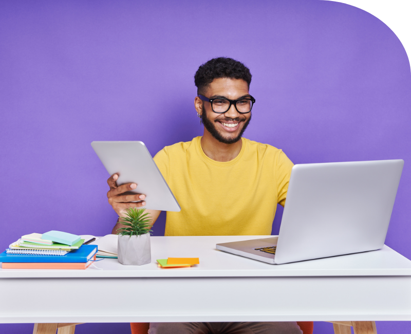 Portrait of a young male employee working on his desk on a laptop